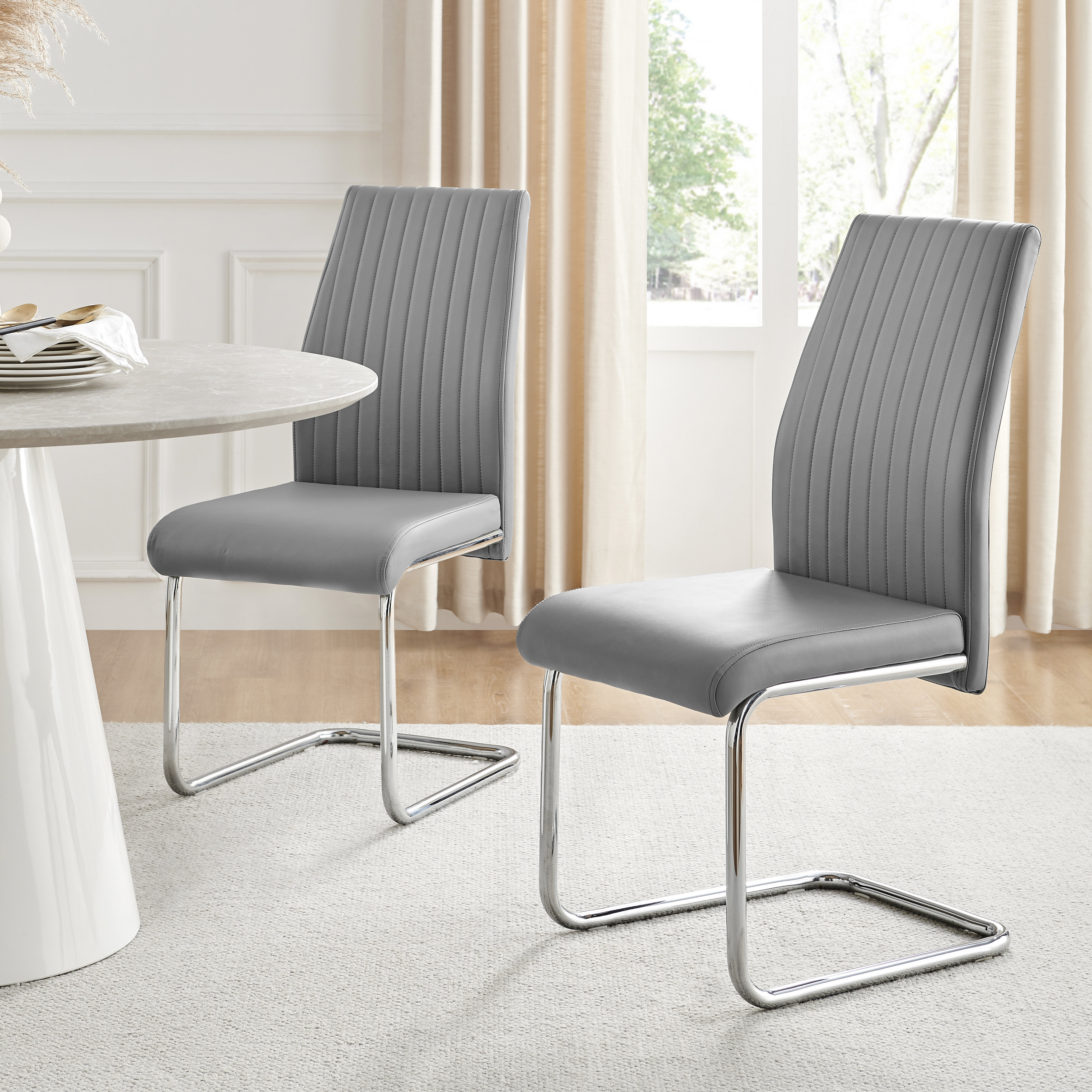 East Urban Home Lazarus Faux Leather Chrome Dining Chairs